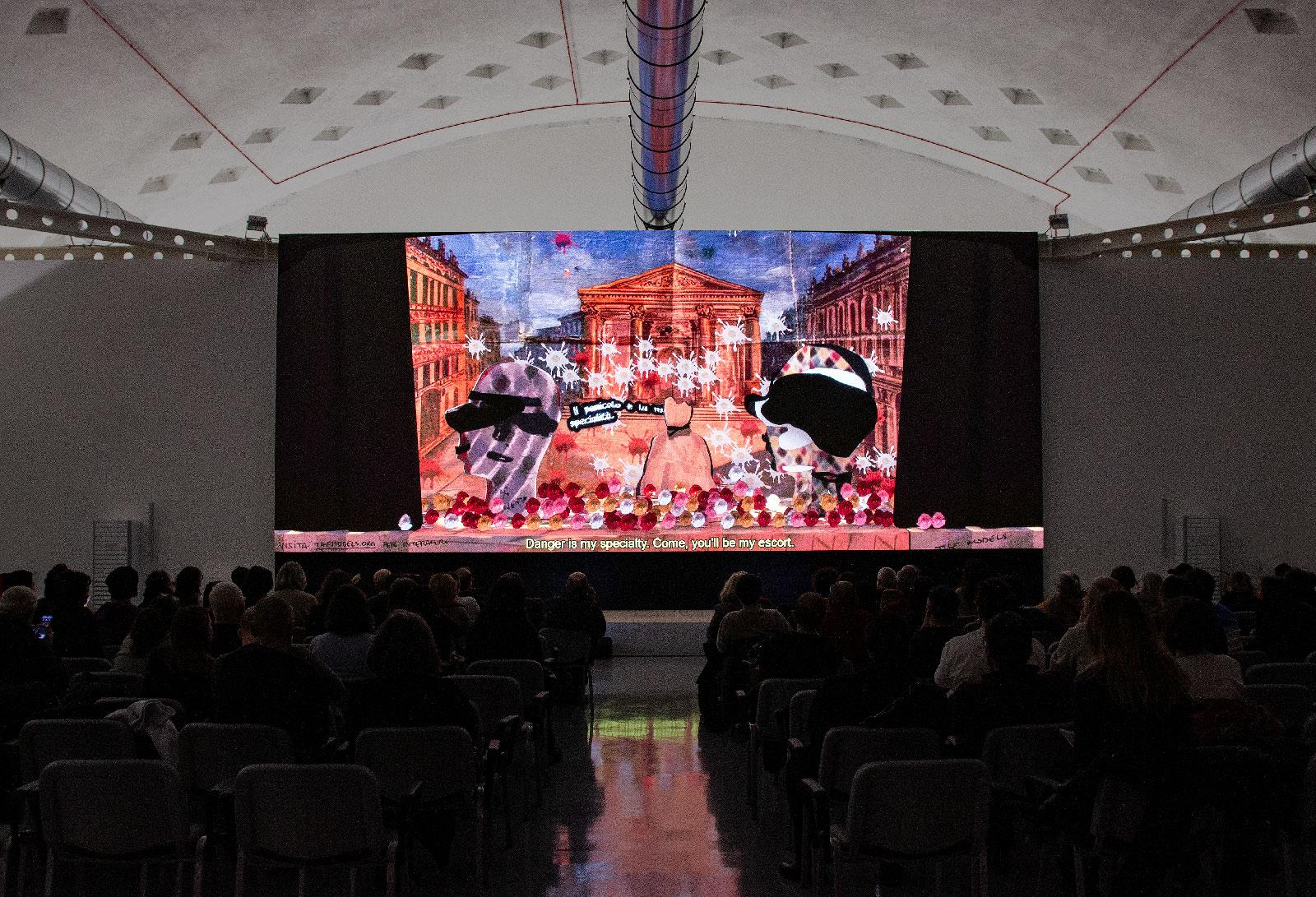 The Models on a large LED screen in front of an audience.